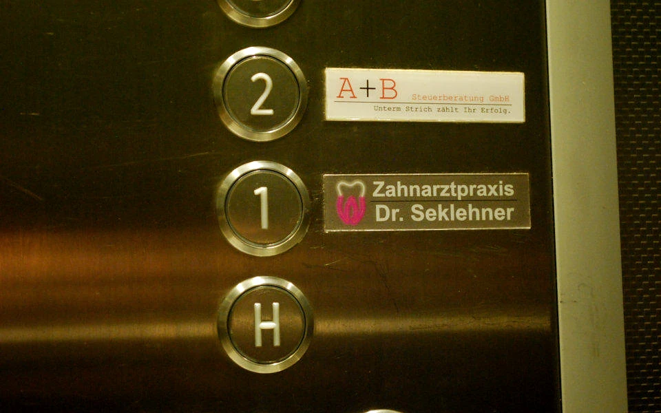 Dental practice sign inside the lift